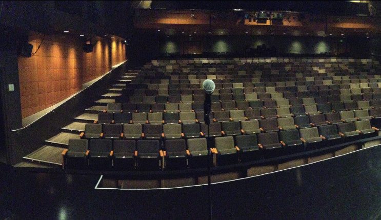 Empty theater seats with microphone, focusing on authority and marketing technology discussions.