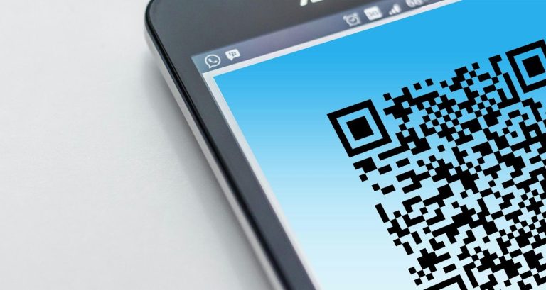Innovative marketing technology and digital authority solutions with QR code on smartphone screen.